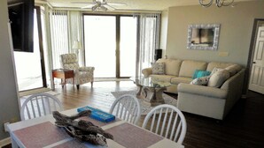 A dining area with a table set for two, a white chair, and a decorative piece on the table.