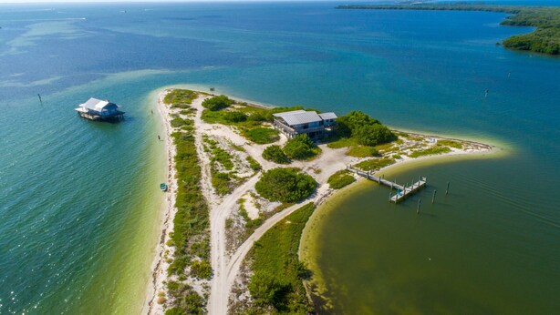 An aerial view of a coastal property with a main building, a dock, and a beach. - North Captiva Point House - Boat/Water Taxi Only **NEWLY RENOVATED ** (North Captiva)