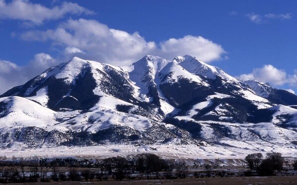 A snow-covered mountain range with a clear sky.