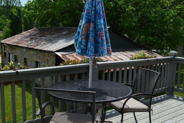 Table and chairs for eating outside. Also has a moveable fire pit downstairs.