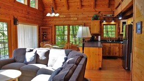 A cozy cabin interior with a living room, dining area, and kitchen. - Serenity on Cedar-Lakefront Cabin- 10 boats-Swim/Fish/Boat, Starlink & Hulu Live (Tuckasegee)