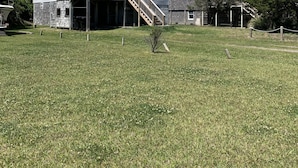 A two-story building with a balcony and a staircase leading to the upper floor. - Frisco Beach House! Some ocean views! Easy walk to the beach!  (Frisco)