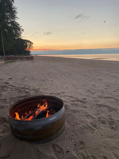 Cute house on Saginaw Bay with hot tub on private beach.