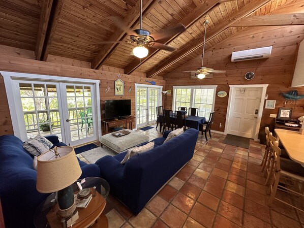 Interior acogedor de una cabaña con sala de estar, comedor y cocina.
