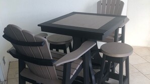 A patio area with a table and four chairs.
