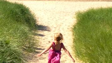 Rannalla, aurinkotuoleja, rantapyyhkeitä