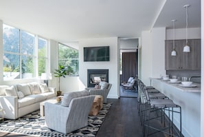 Enjoy a peaceful retreat with a forest view, comfortable seating area, and cozy fireplace.