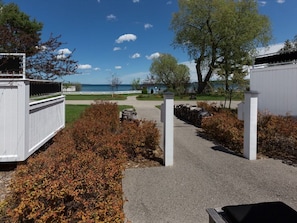Stroll along the tranquil pathway to our serene retreat, surrounded by lush greenery and a picturesque view of the water.