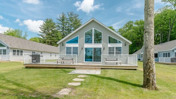A modern two-story house with large windows, a covered porch, and a well-maintained lawn. - Vast Lakefront Home with Rec Room and Fire Pit (Pullman)