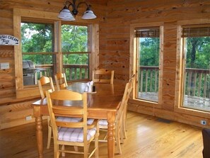 Cozy cabin interior with a dining area featuring a wooden table and six chairs.