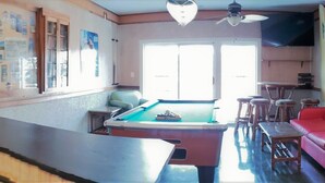 A kitchen with wooden cabinets, a stainless steel refrigerator, a stove, and a sink. - In the HEART of North Myrtle Beach (North Myrtle Beach)