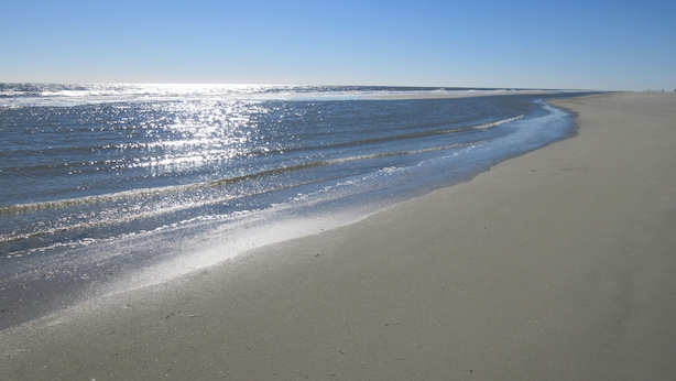A beach with a wide sandy shore and gentle waves. - Villa; 5 minute walk to Palmetto Dunes Beach with a Great Golf Course View!! (Hilton Head Island)