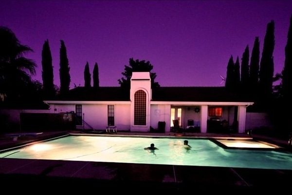 Guests enjoying the pool at night.