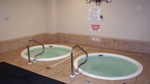 A pool area with two hot tubs, safety signs, and numbered steps. - Inquiries are Beginning for Spring and Summer. Hear the Waves from  the Balcony. (Gulf Shores)
