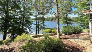 A paved walkway leading to a lake with trees and shrubs. - Large Family Lakehouse w/ Dock, Deck, Patio, Views (Semora)