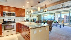 A modern kitchen with stainless steel appliances, wooden cabinets, and a large island. - Amazing Ocean/Mountain Views. Beautifully.One From Oceanfront (Lahaina)