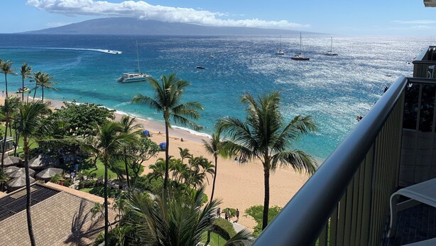 A beach view with a clear sky, palm trees, and boats on the water. - Amazing Ocean/Mountain Views. Beautifully.One From Oceanfront (Lahaina)