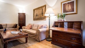 A living room with a wooden coffee table, beige sofa, and a wooden cabinet. - Classy apartment with lake-view terrace and parking (Cernobbio)