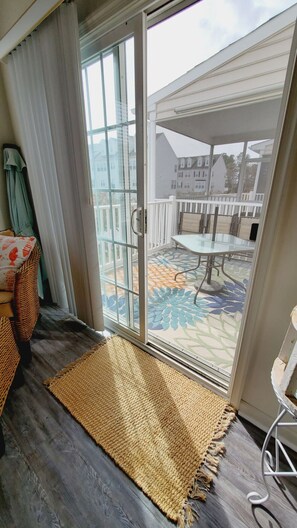 Step outside to a patio with a patterned floor and comfortable seating.
