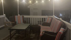 A covered outdoor seating area with a sofa, chairs, and a table. - ATV and Snowmobile right from the house !!!! (Berlin)