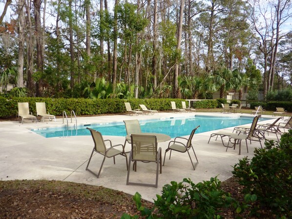 A swimming pool with lounge chairs and a forested background. - SeaPines, Updated, Walk to the Beach Club, Pet friendly, Two free bikes (Hilton Head Island)