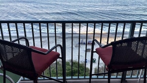 A balcony with two chairs facing the ocean. - "Chasing Waves"-Oceanfront Luxury King Condo w/ Kitchen, Living Room & that View (Myrtle Beach)