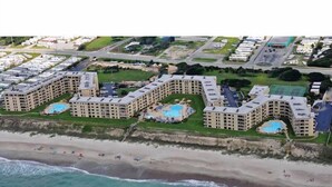 A coastal hotel with multiple buildings, each featuring a swimming pool and a beach view. - Oceanfront! Private Beach Access. Prime location, building A-main pool & complex (Indian Beach)