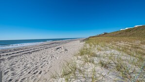 A sandy beach with a clear blue sky and ocean. - Oceanfront! Private Beach Access. Prime location, building A-main pool & complex (Indian Beach)