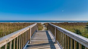A wooden boardwalk leading to a beach with clear skies. - Meticulous Oceanfront 1Bedroom Suite/ Jetted tub! (Myrtle Beach)