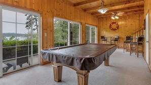 A wooden interior with a pool table, large windows, and a view of the outdoors. - Log Cabin On Lake Keowee-Big Lake Mountain Views (Six Mile)