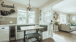 A kitchen with a built-in bench, a chandelier, and a dining table. - Contemporary Boutique Bungalow+Backyard+Walkable (San Luis Obispo)