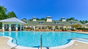 A swimming pool with lounge chairs and a covered seating area. - Huge Home Situated on Golf Course; Close to Beach, Outlets, and Restaurants! (Berlin)