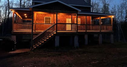 Hot tub, piscine chauffée et bar extérieur sur un terrain spacieux et boisé.