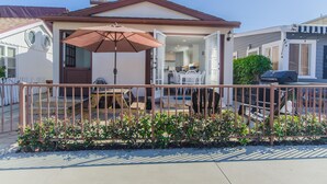 A house with a patio, a dining area, and a garage. - Air Conditioning! Cottage 2-blocks from Beach (Newport Beach)
