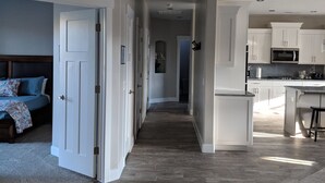 Ein modernes Interieur mit einem Flur, der zu einem Schlafzimmer und einer Küchenzeile führt.