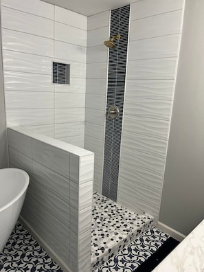 Bathtub, hair dryer, soap, toilet paper