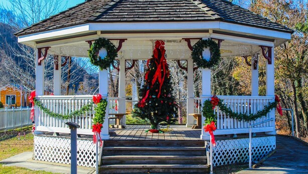 A gazebo with a white exterior, red and green decorations, and a Christmas tree. - Newly Renovated Country Home Located near Greenbrier River (Alderson)
