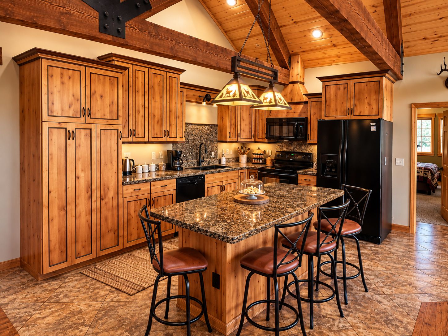 A kitchen with wooden cabinets, a granite countertop, a black refrigerator, and a bar area with stools.