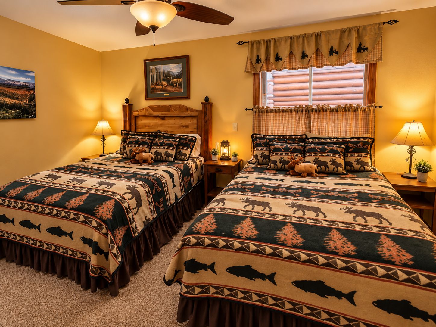 A double bed with a patterned bedspread, two bedside tables with lamps, a ceiling fan, and a window with curtains.