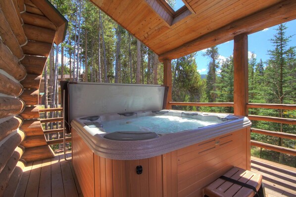 A wooden hot tub on a deck with a view of a forest. - Log Home Retreat, outdoor living w/ grill, pool table, 2mi to Ski & Main St. (Breckenridge)