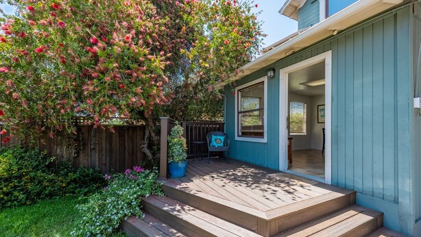 A house with a wooden deck, a small porch, and a garden with various plants and flowers. - Family Friendly 3BR Getaway! Central, Convenient, & Charming. (San Diego)