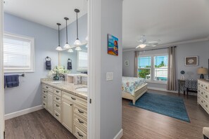 A bedroom with a bed, a dresser, a nightstand, a window with curtains, and a view of the outdoors. - Private 4/3 Pool Heater/Dock/Kayaks/Bikes,etc (Marathon)