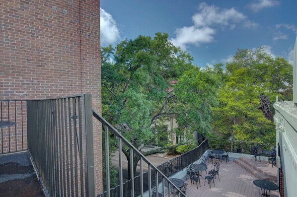 A courtyard with outdoor seating and a brick building.