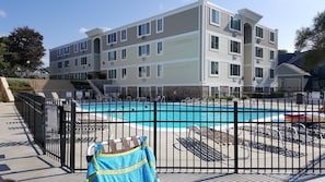 Relax by the pool surrounded by lounge chairs and umbrellas.