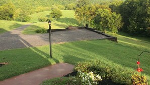 A lush green landscape with a gravel path and a red brick walkway. - Breathtaking Country Paradise with hot tub  where you can unplug in nature  (Beechgrove)
