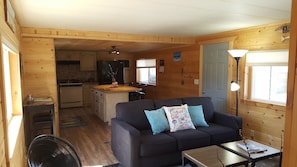 A cozy cabin interior with a living area, kitchen, and dining space. - Close to Wheeler's Point Boat Launch! (Baudette)