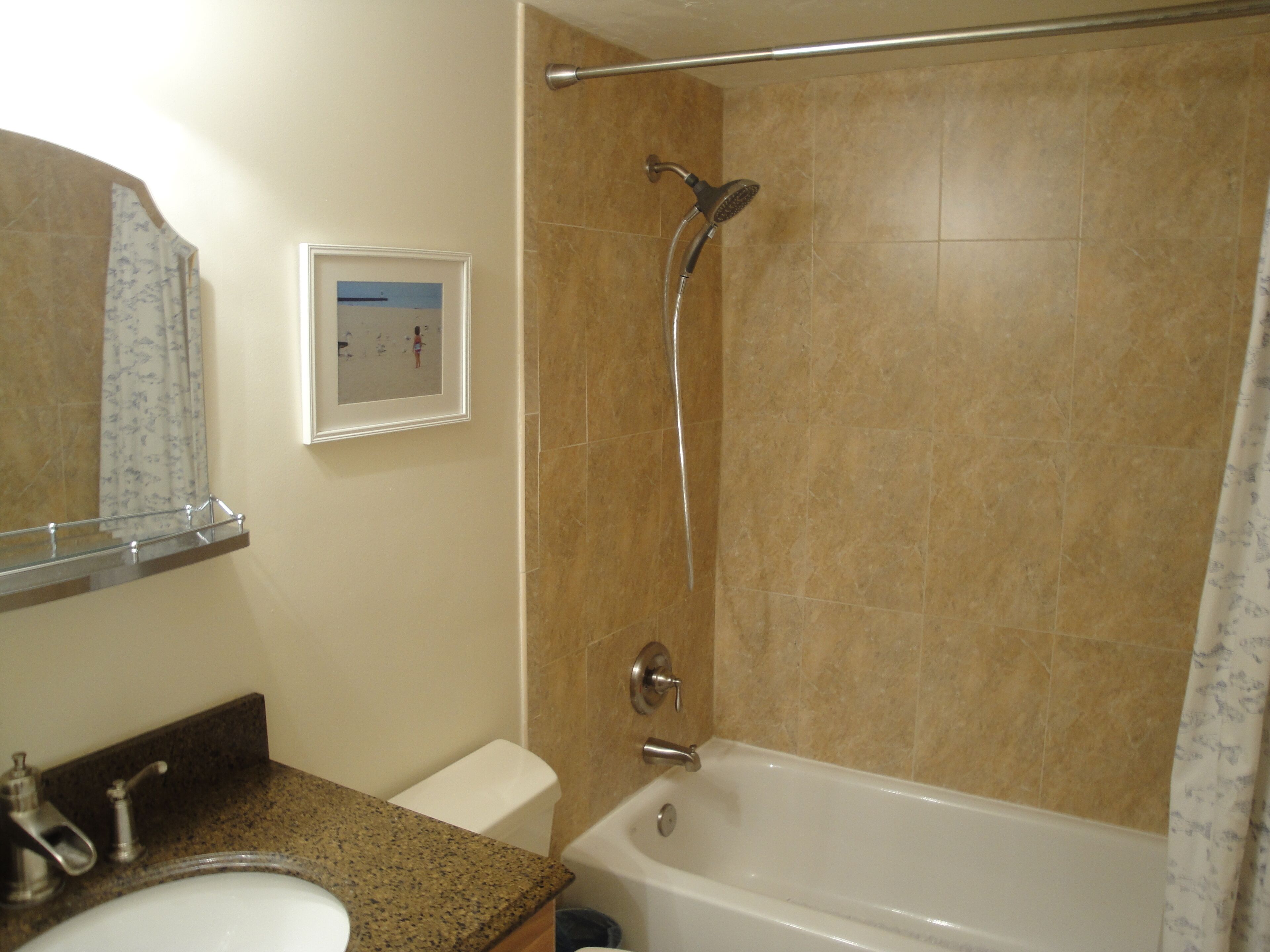 A bathroom with a bathtub, a toilet, a sink, and a shower.