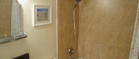 A bathroom with a bathtub, a toilet, a sink, and a shower.