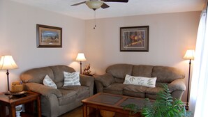 A living room with two sofas, a coffee table, and two side tables with lamps. - Peaceful Country Cottage with Game Room & Hot Tub (Beattyville)