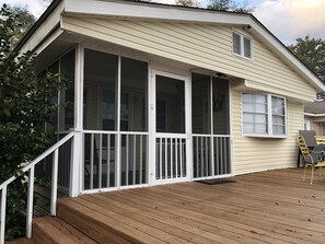 A house with a covered porch and a wooden deck. - Ocean and Lake views, Pet friendly, Golf cart. (Myrtle Beach)